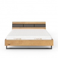 Łóżko na metalowej ramie z tapicerowanym elementem na zagłówku - Möbel Assen
